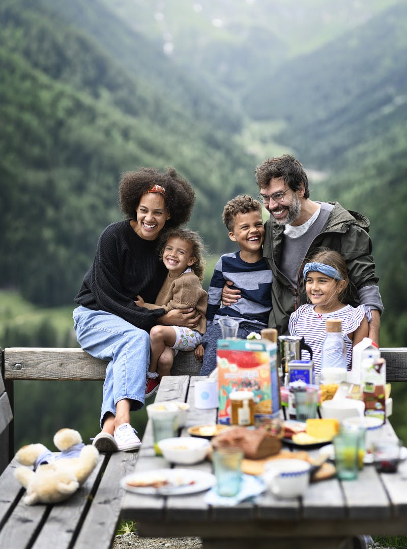 A family has a picnic on their RV vacation through the Austrian mountains.