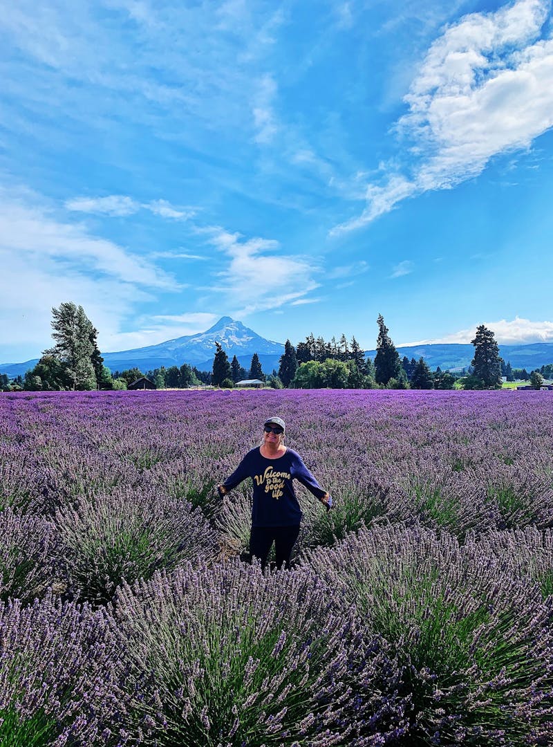 A woman posed in a field of lavender.