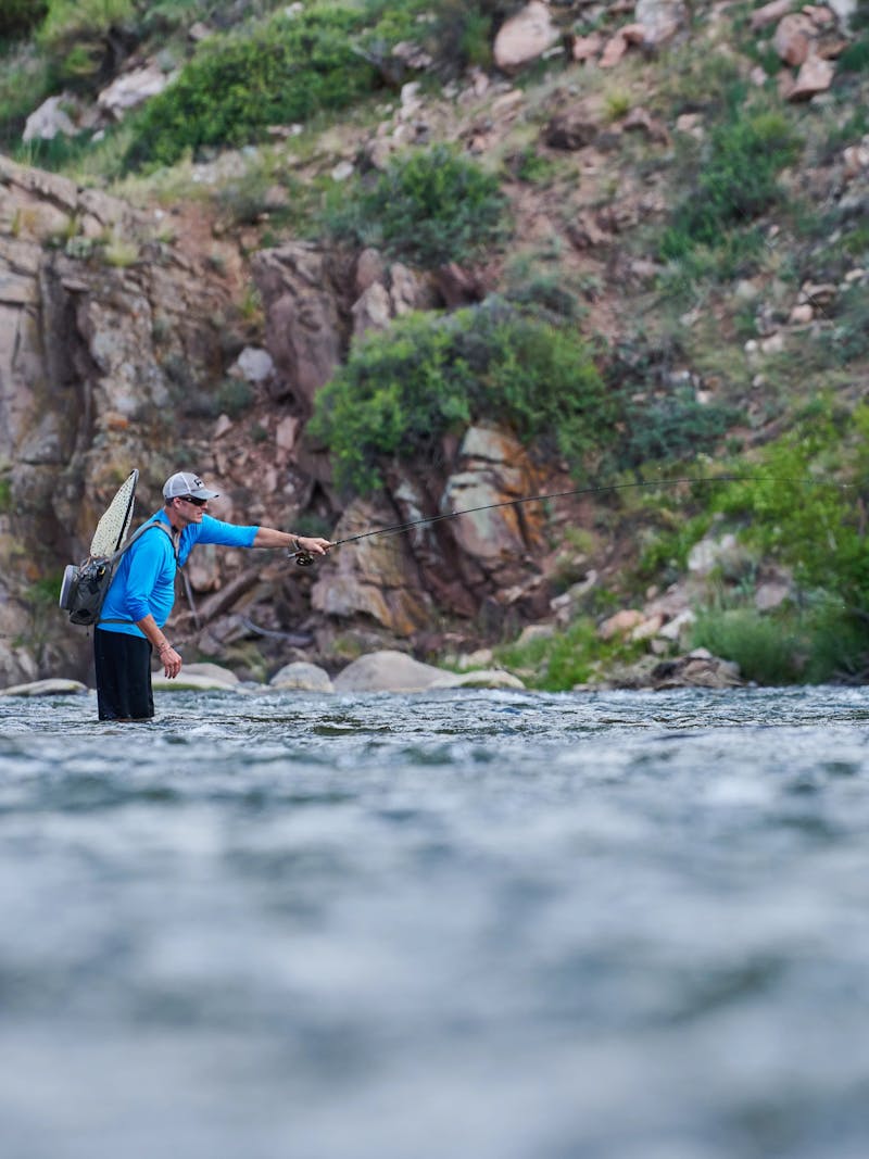 CHRIS HEUBLEIN fishing in a river