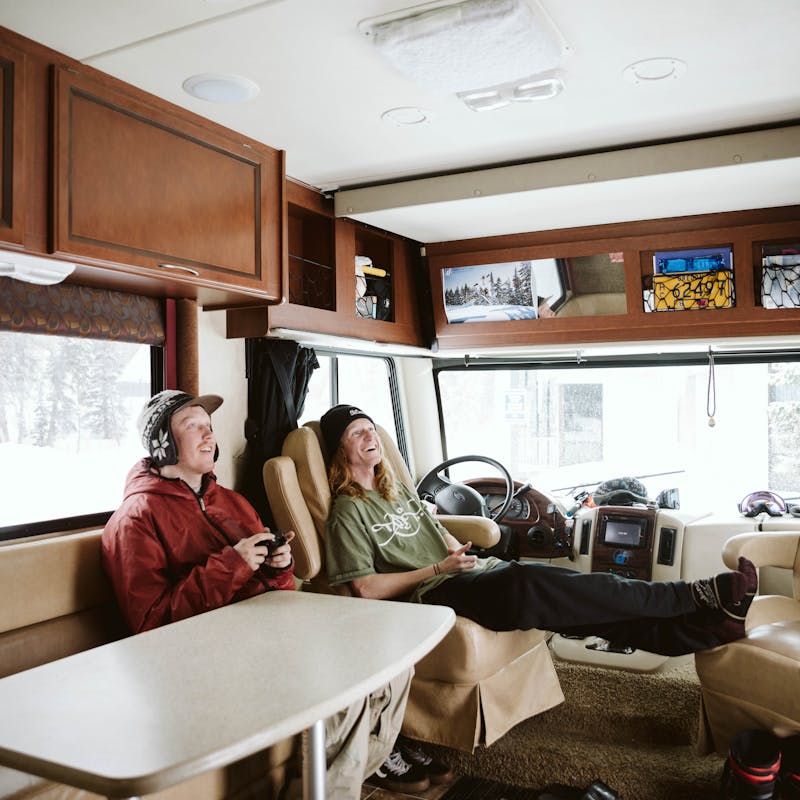 Ryan and his friend playing video games in the RV.