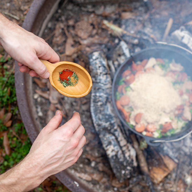 Adding rice and spices to the pot.