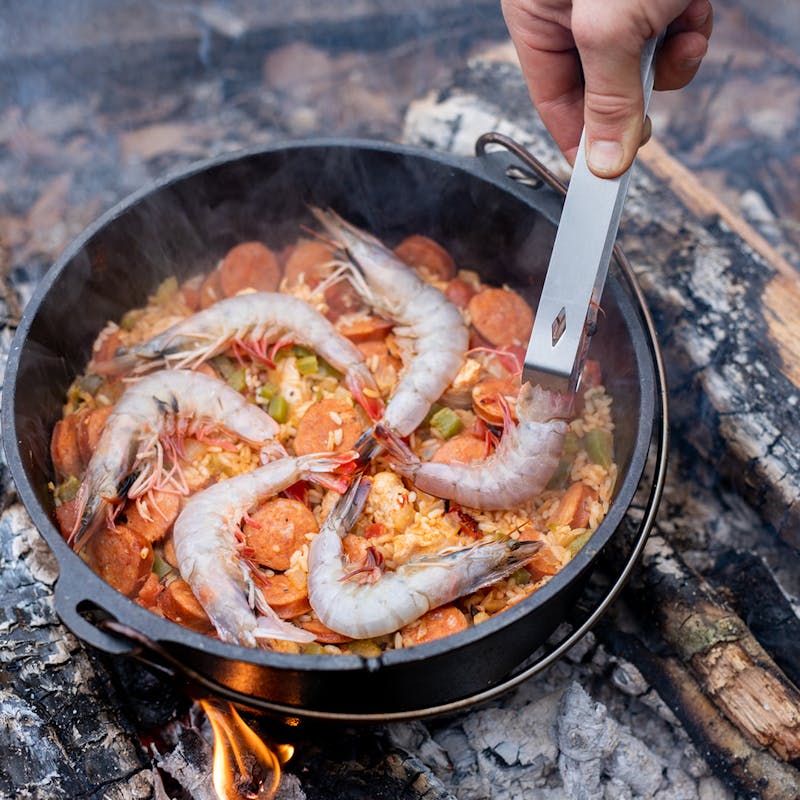 Adding in tomato sauce to the jambalaya.