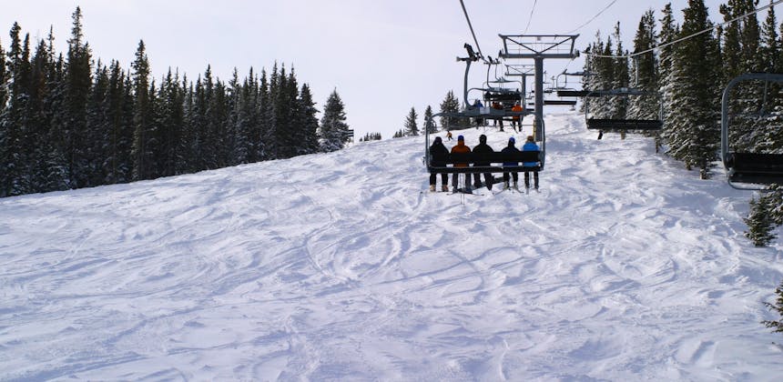 A chair lift carrying people up Copper Mountain.
