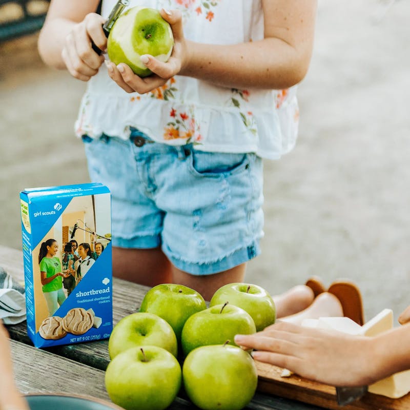 Girls peeling green apples