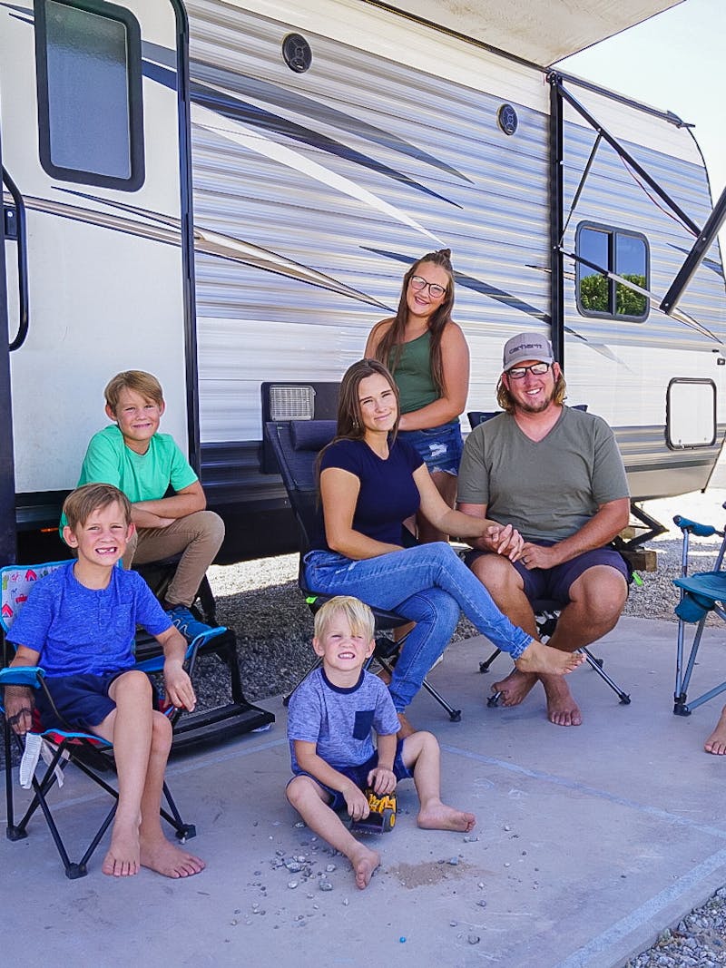 Renee Tilby and her family take a photo in front of their Jayco Jay Flight