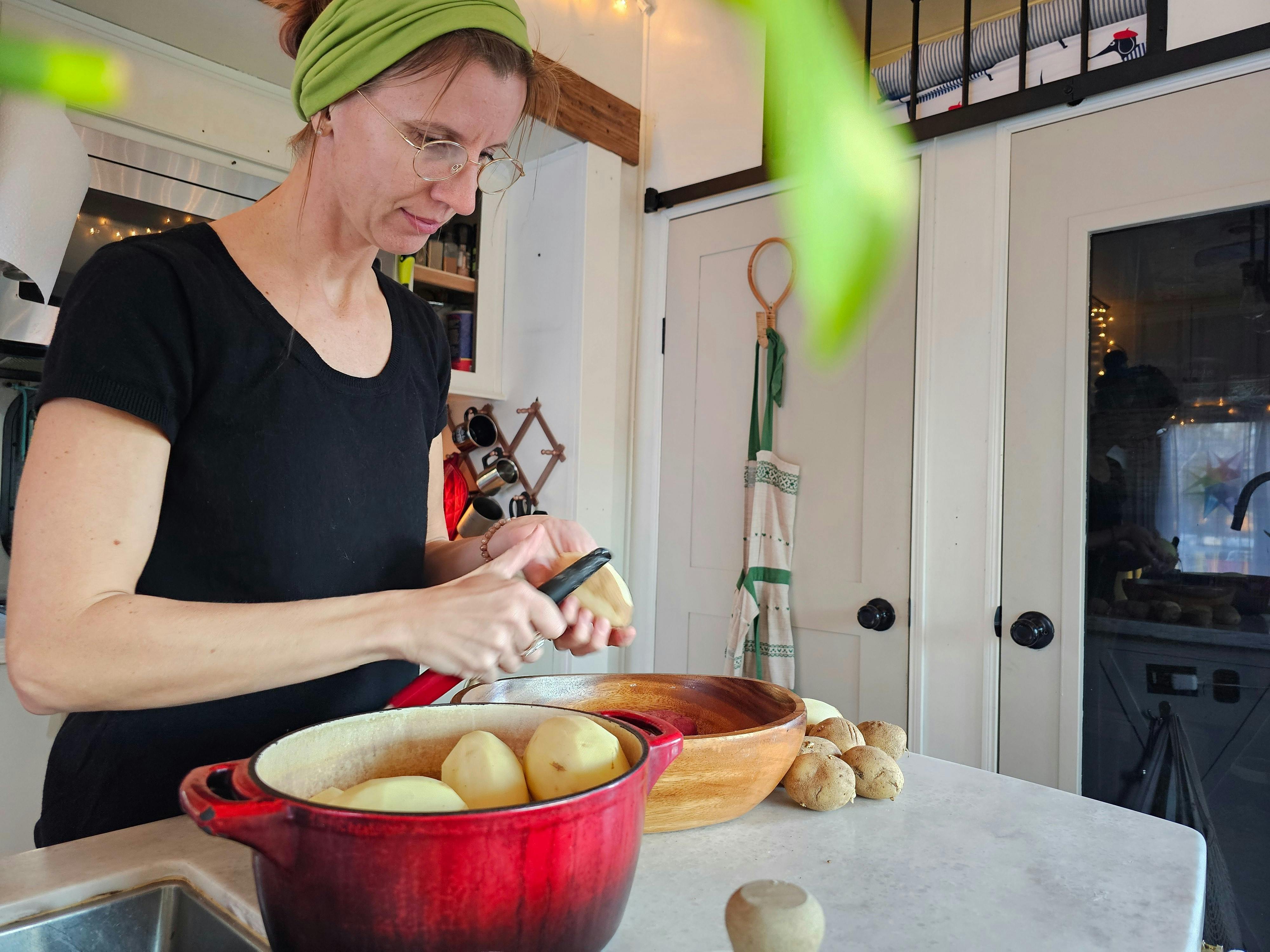Bibi Barringer prepares potatoes in the kitchen of her KZ Durango fifth wheel.