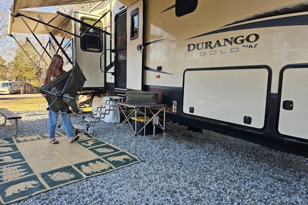 Bibi Barringer packs up a camp chair and patio furniture into her KZ Durango fifth wheel.