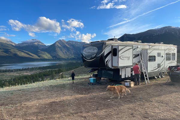 Melissa and Lucas Lahr's Heartland Torque toy hauler at a campsite with panoramic mountain views.