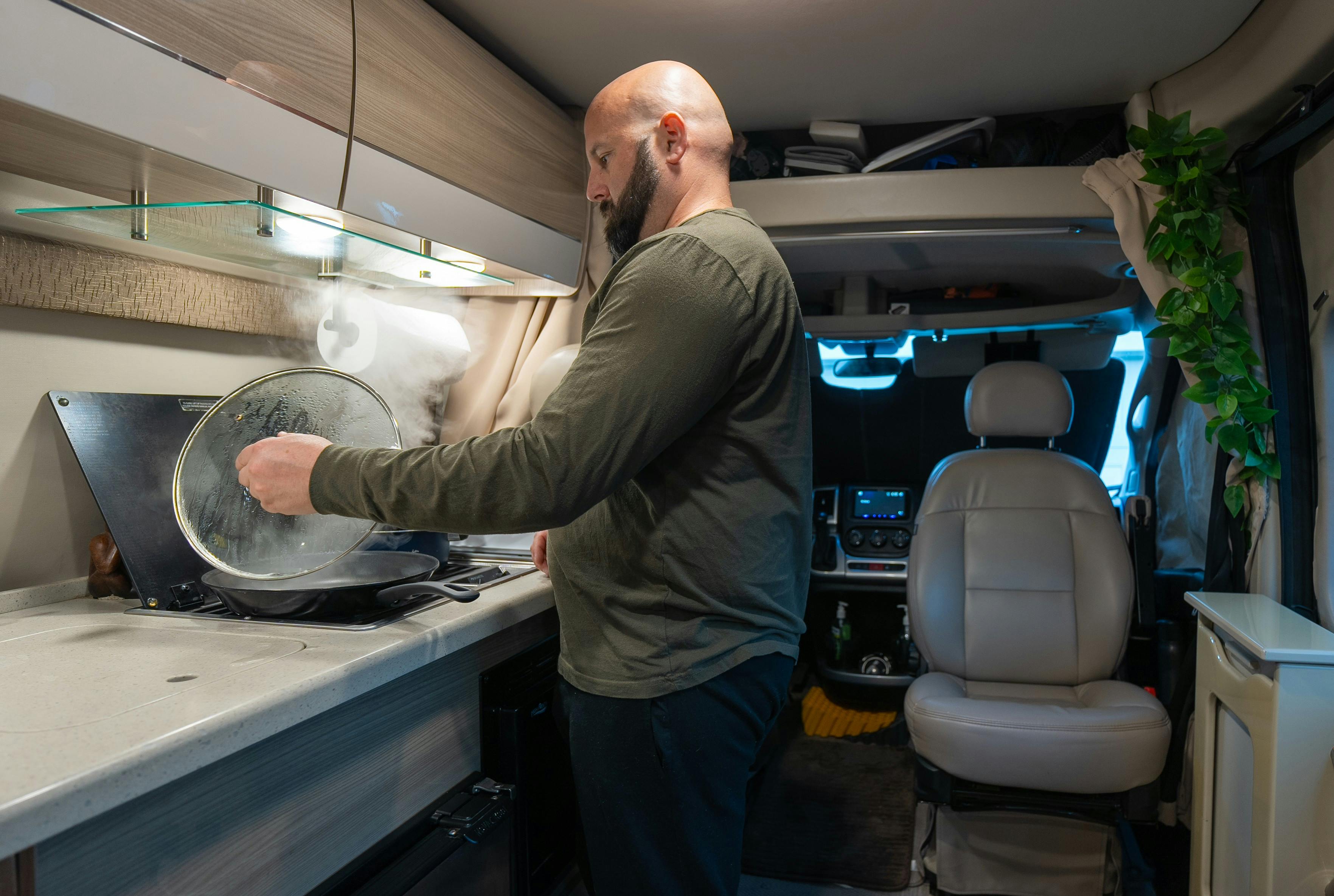 Gabe Rivero cooking on the gas burner stovetop inside his Thor Motor Coach Sequence.
