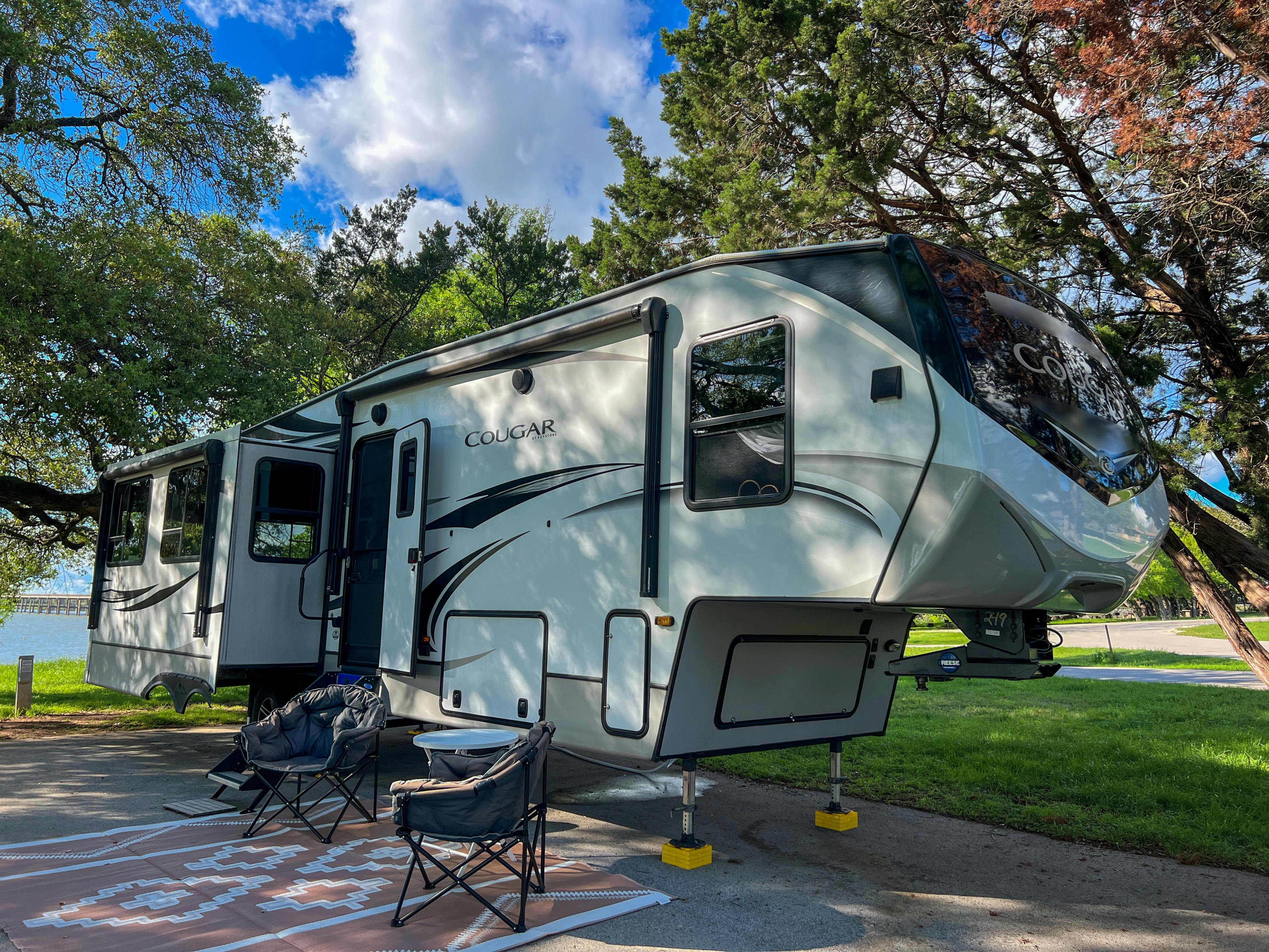 Donny and Tammy Benedict's Keystone Cougar travel trailer at a campsite.