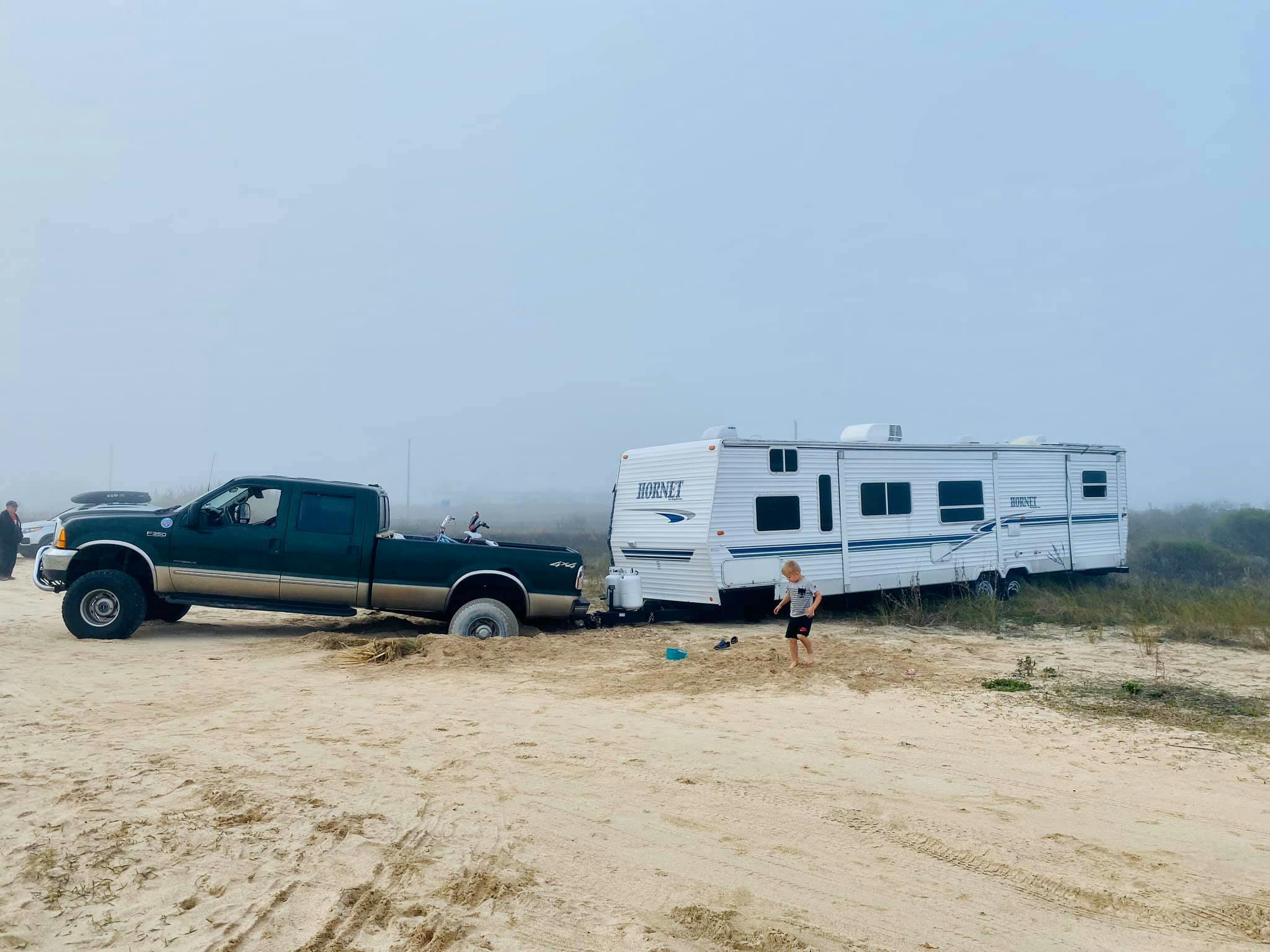 Cassie and Joshua Bailey's Highland Ridge Open Range fifth wheel stuck in the sand.