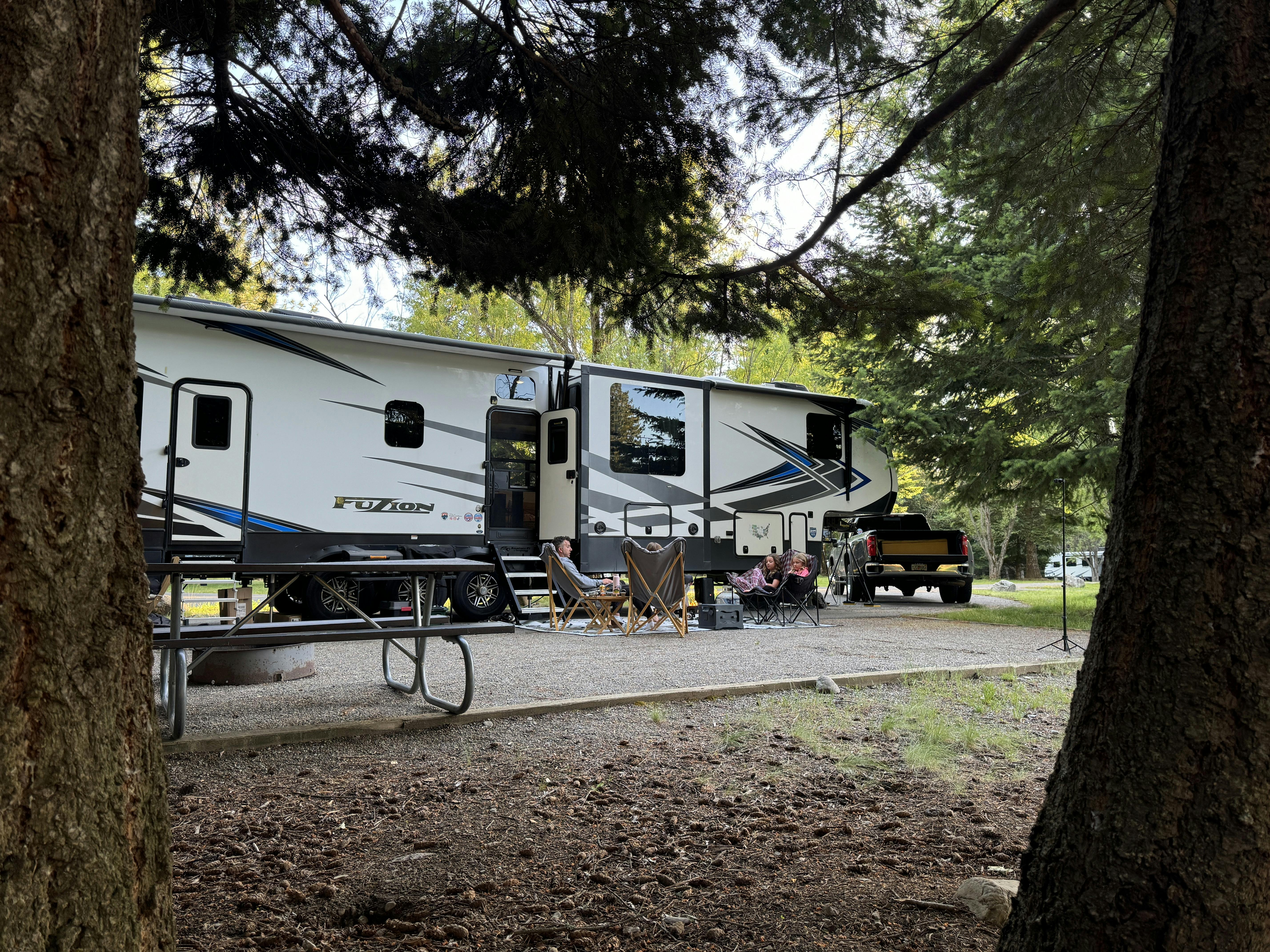 Ashley Peeples enjoying a campfire outside of their Keystone Fuzion toy hauler.