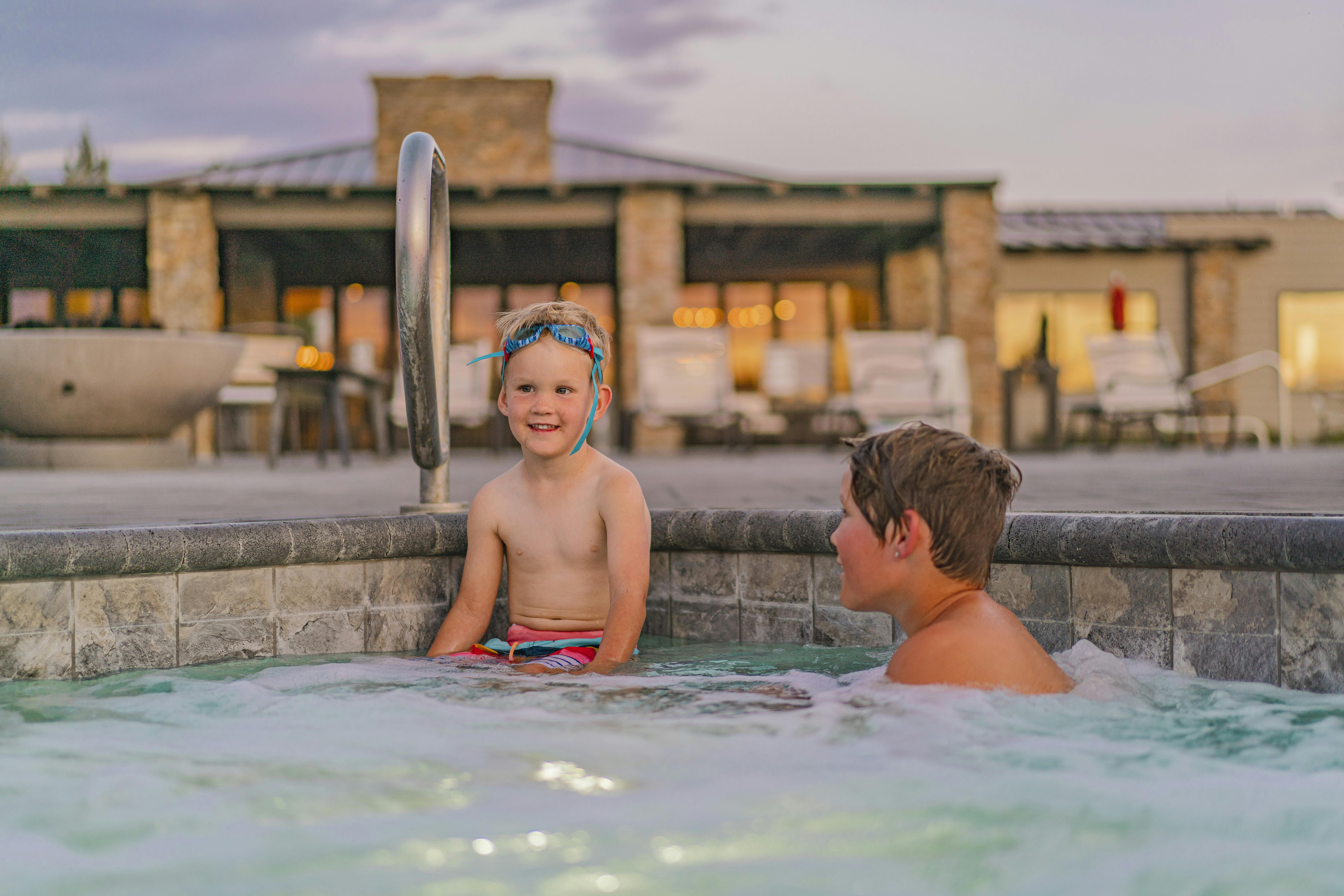 Renee Tilby's kids sit in a hot tub at a campground.