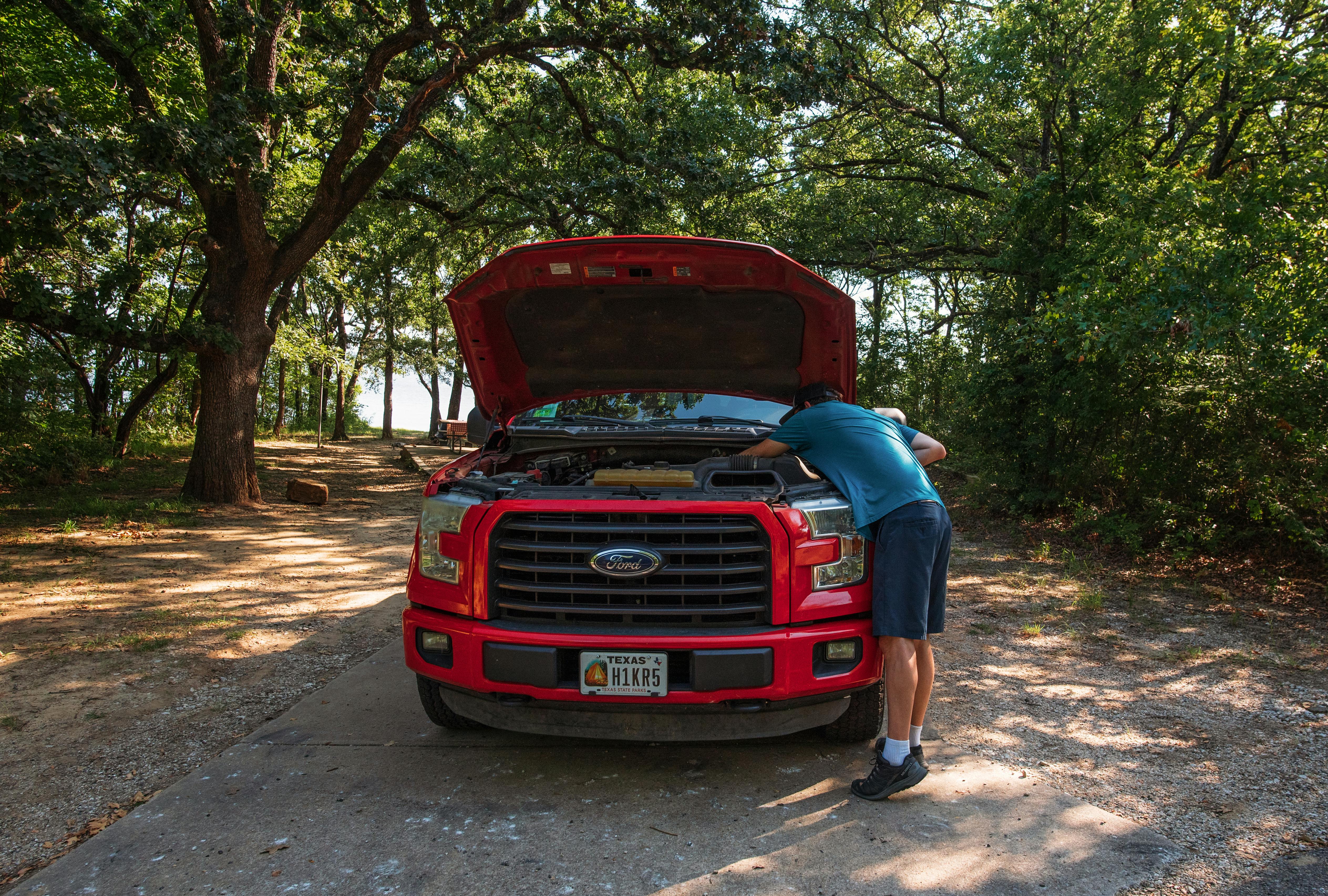 Jason Takacs does maintenance on his truck.