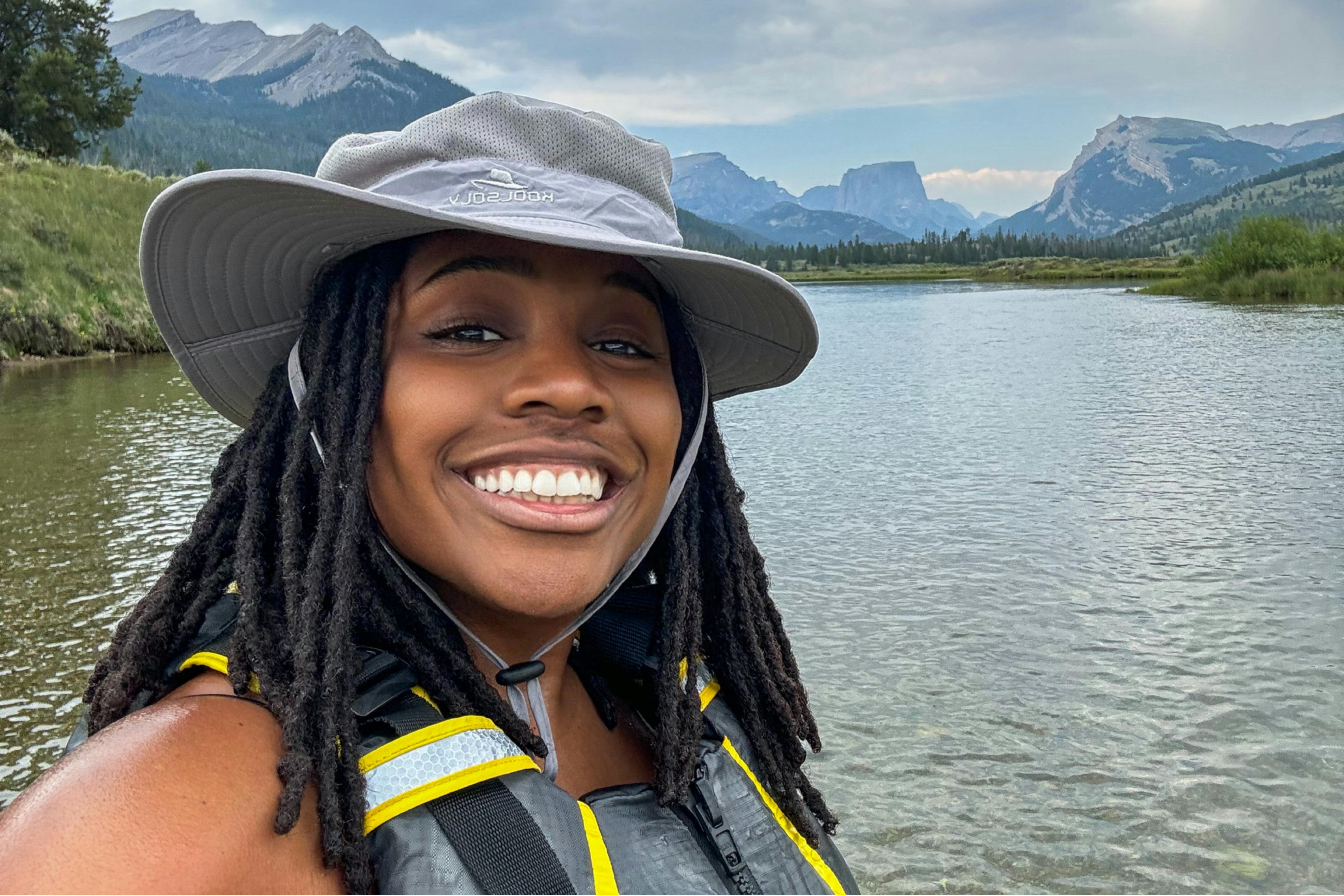 Sherise Gumbs posing in front of the Green River in Bridger-Teton National Forest.