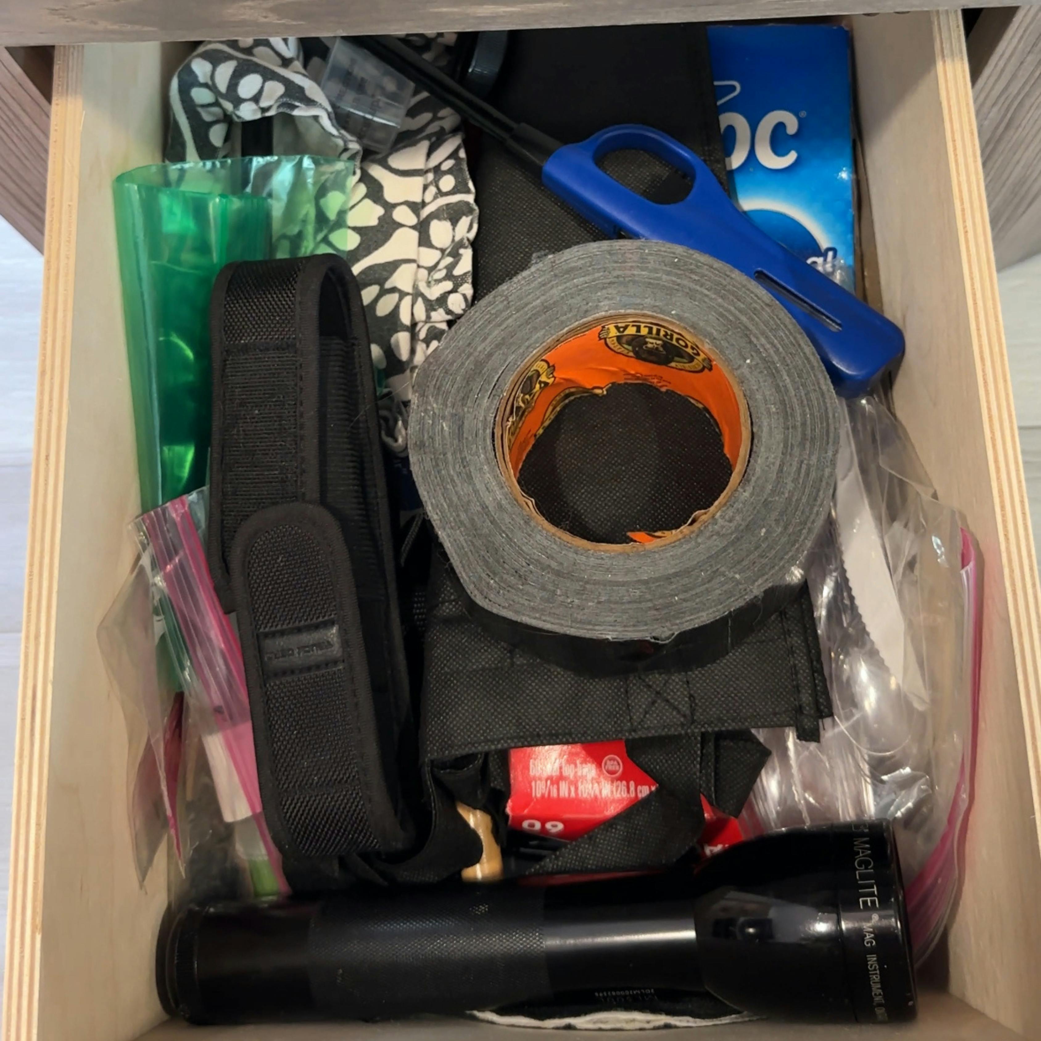 A drawer of safety and essential items inside John King's Cruiser MPG travel trailer.