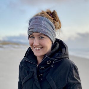 A portrait of Cara Hefty on the beach.