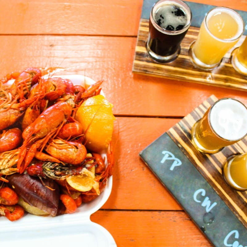 Jesse & Rachael Lyons at a restaurant with beer flights and a seafood feast.