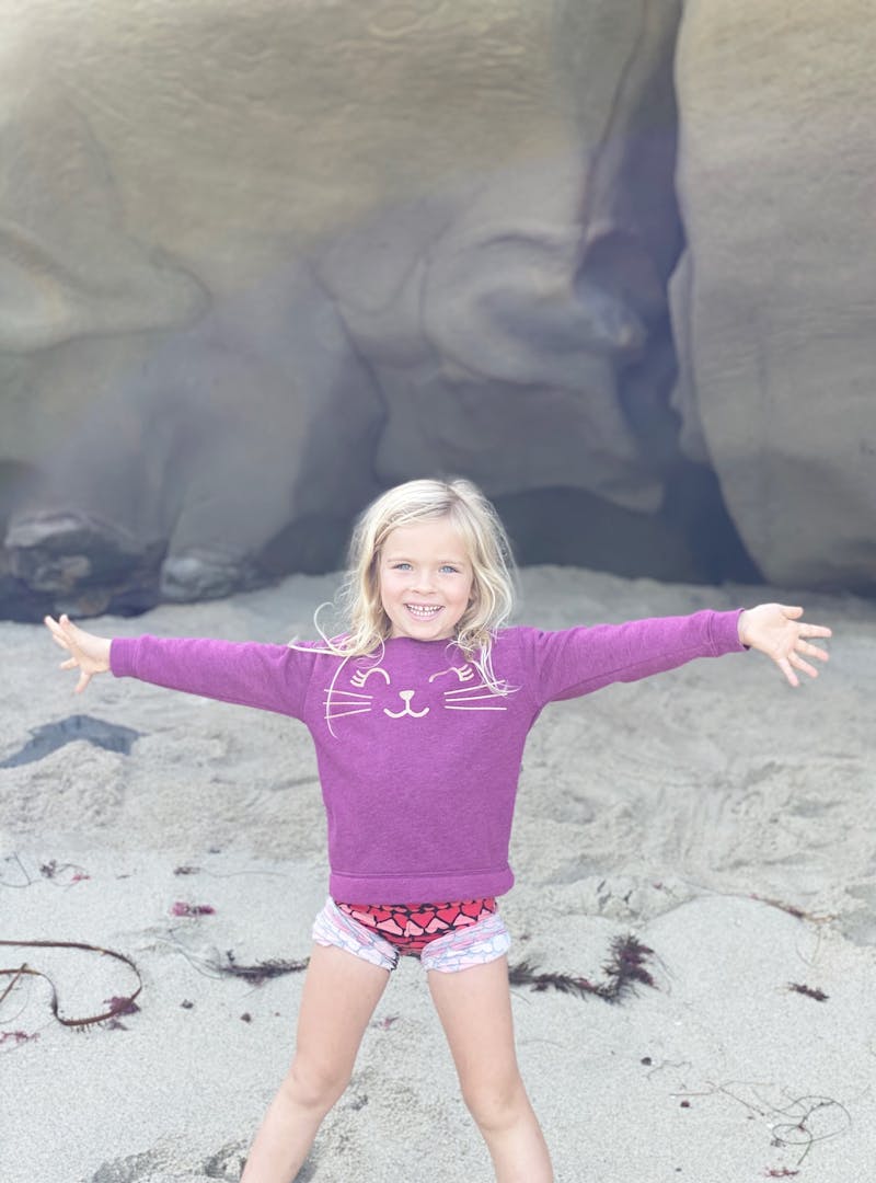 A young girl playing outside during the day.