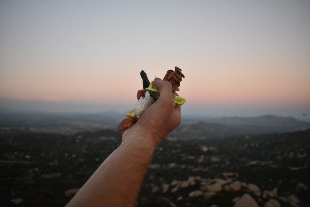 hand picking up trash