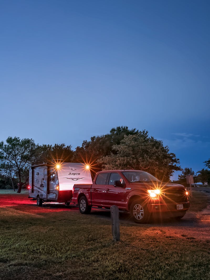 Jason Takacs parking his vehicle and jayco travel trailer at a campsite at night