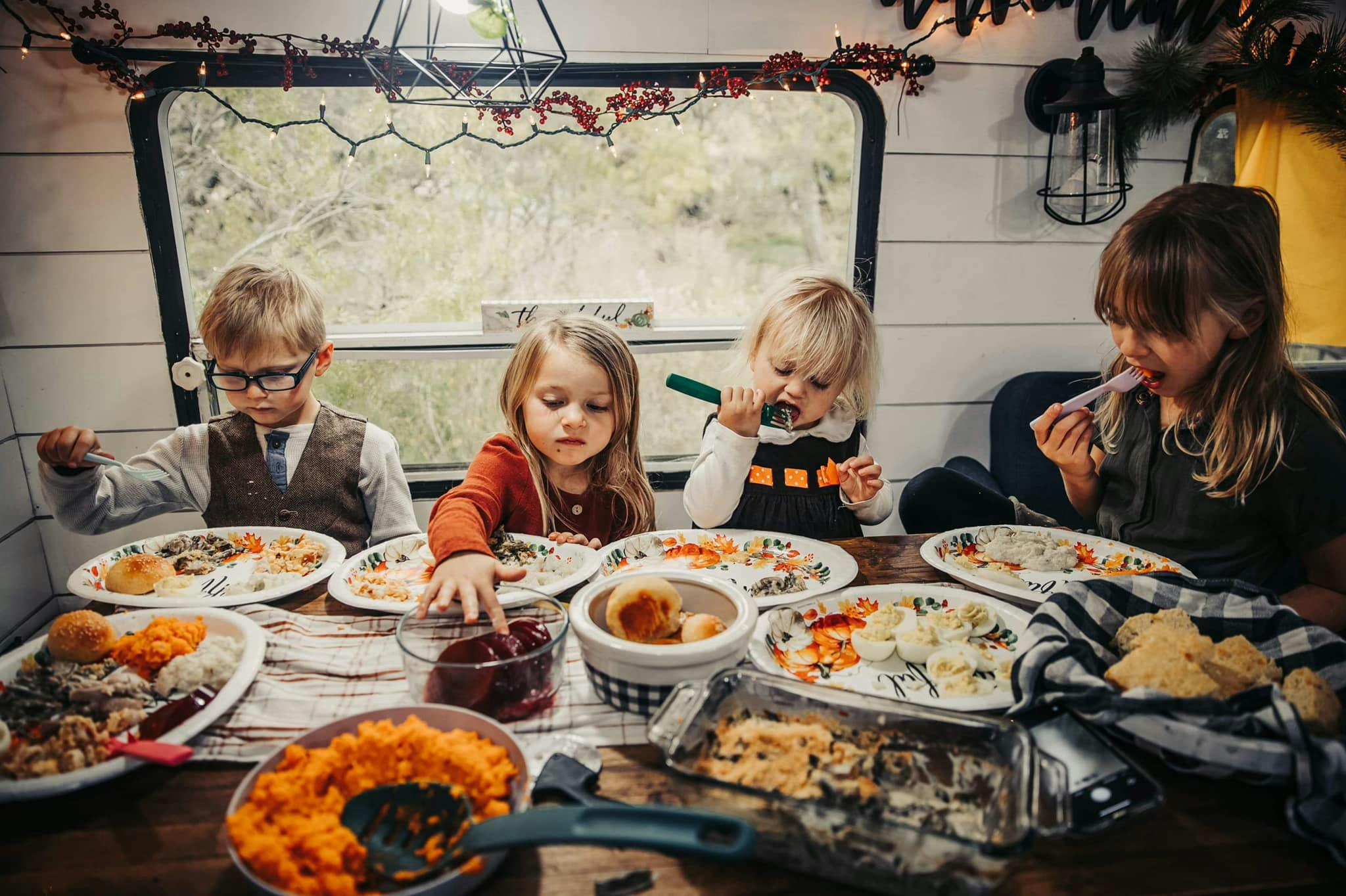 Cassie Bailey's kids eating thanksgiving dinner inside their RV
