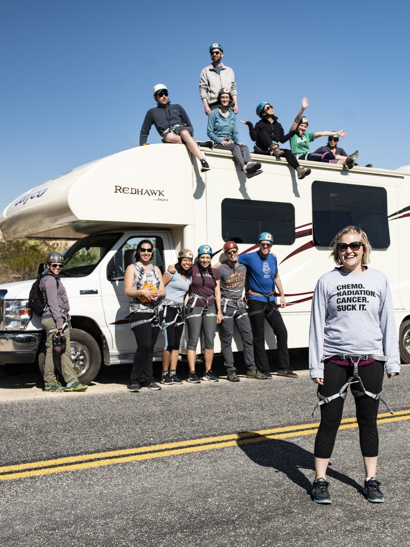 Participants from First Descents gather around a Jayco Class C RV in Joshua Tree National Park. 