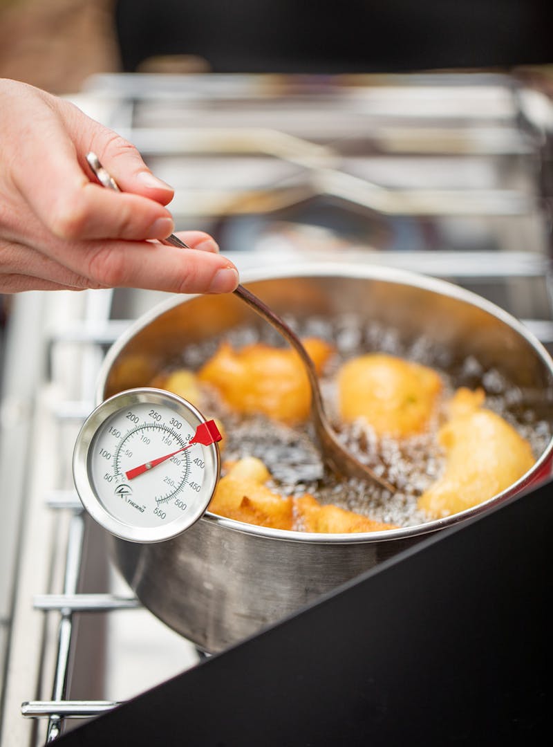 Frying hush puppies in a pot of oil.