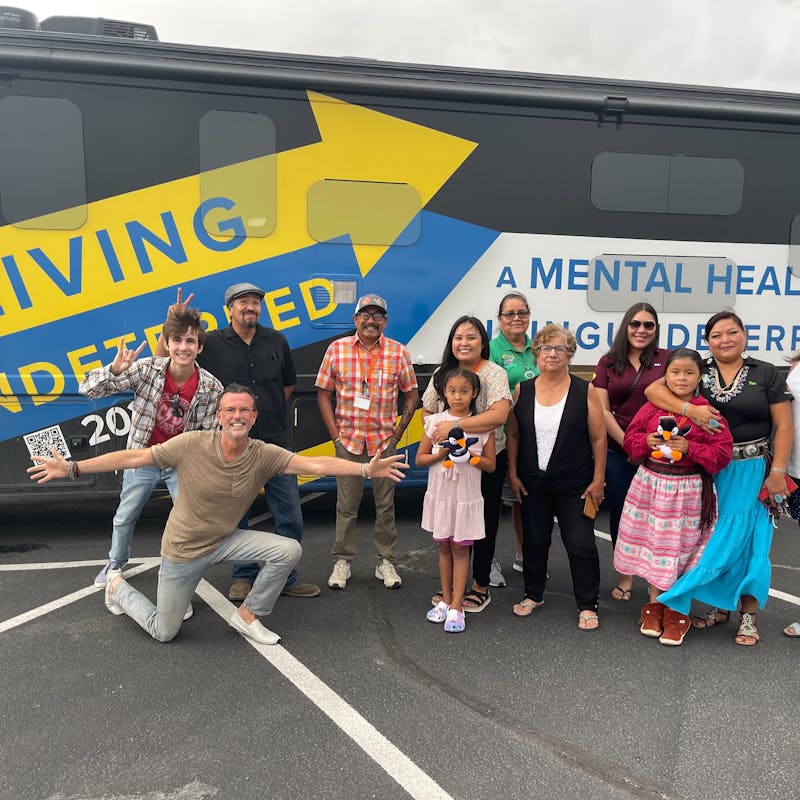 Jeff Johsnton with a large group of people posting in front of his RV