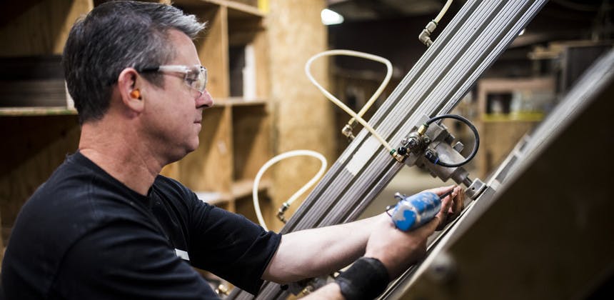 Man working in factory with high tech equipment