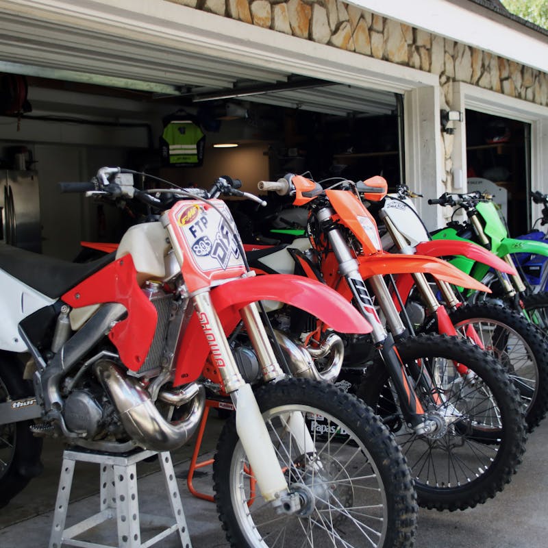Dirt bikes raised up on blocks to tune them up before a trip.