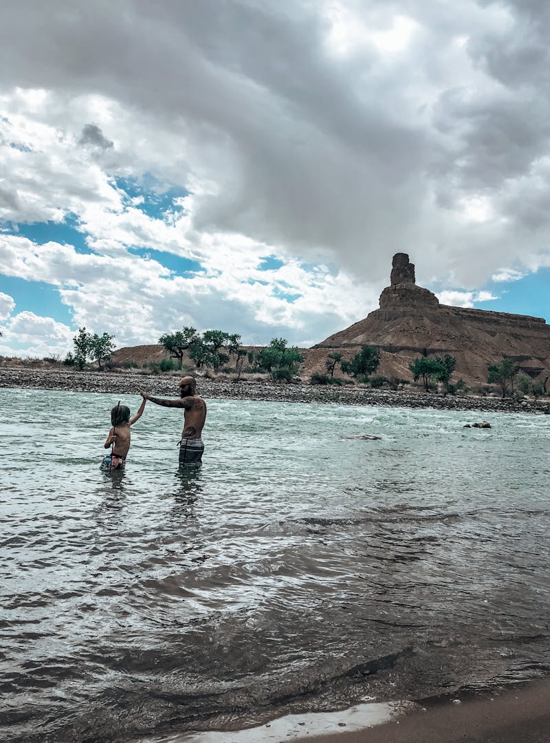 Justin Russell and his son play in a lake.