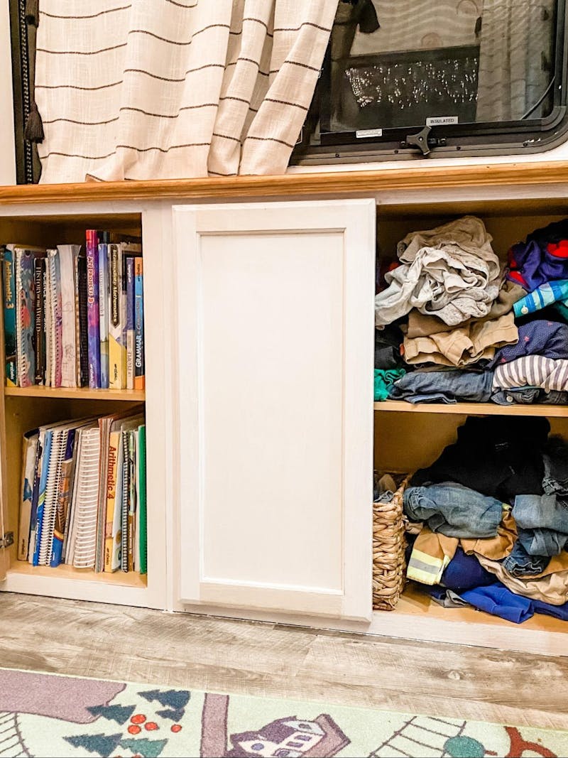 Clothes and school work organized in storage cupboards inside Brittnee Proha's Heartland Cyclone.