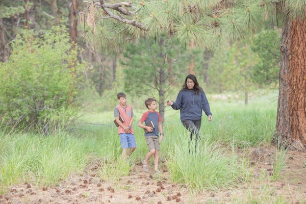 Chelsea Day walks through a forest with her children
