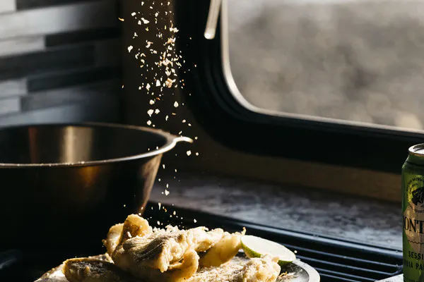 Plate of Fried White Fish with Lime Salt in kitchen RV. 