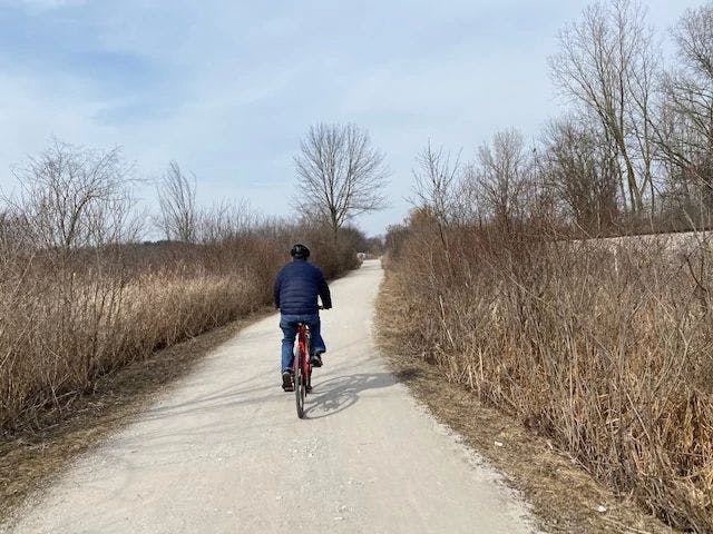Matt Gleason biking on a trail