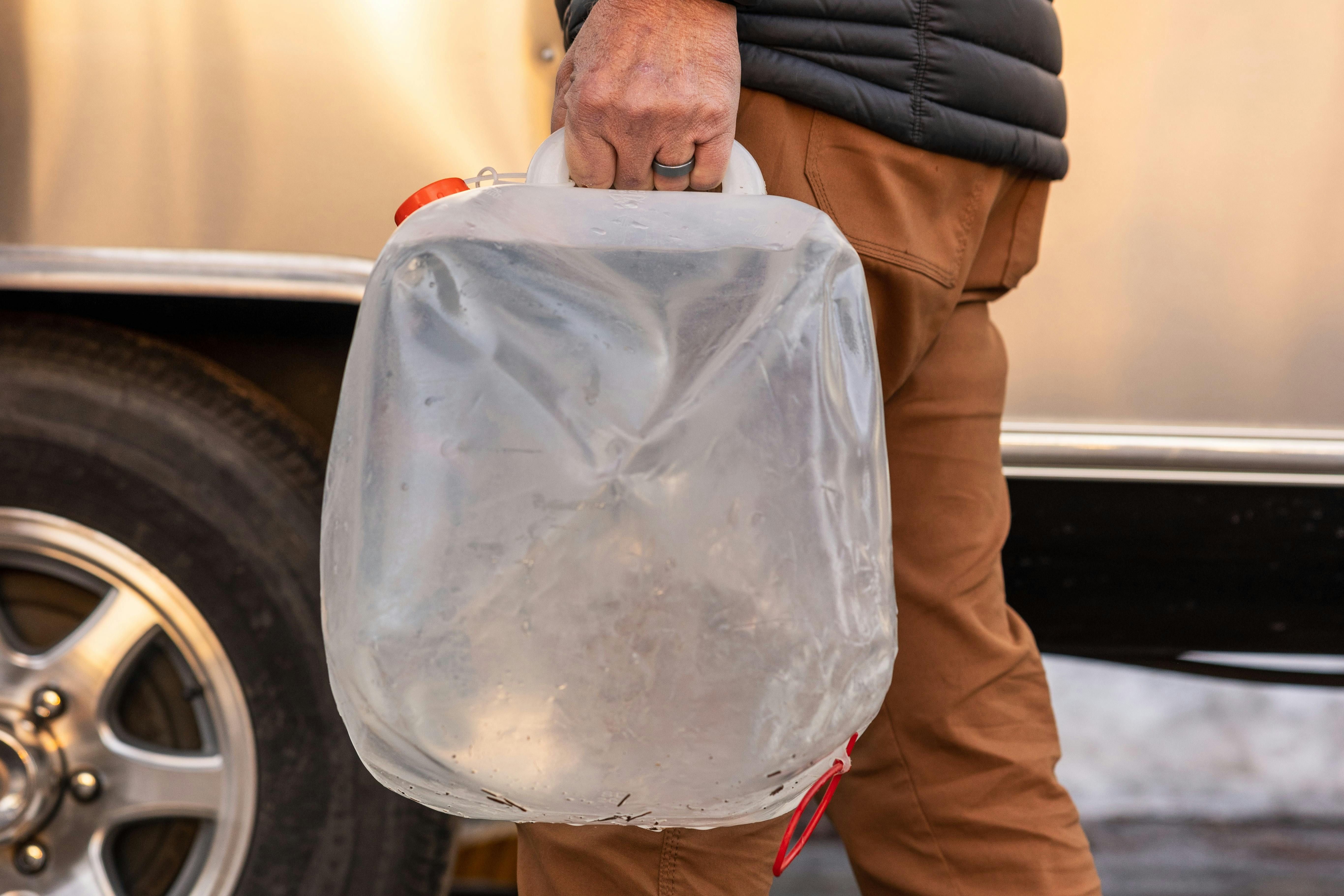 Karen Blue's husband Lenny holding a bag of water 