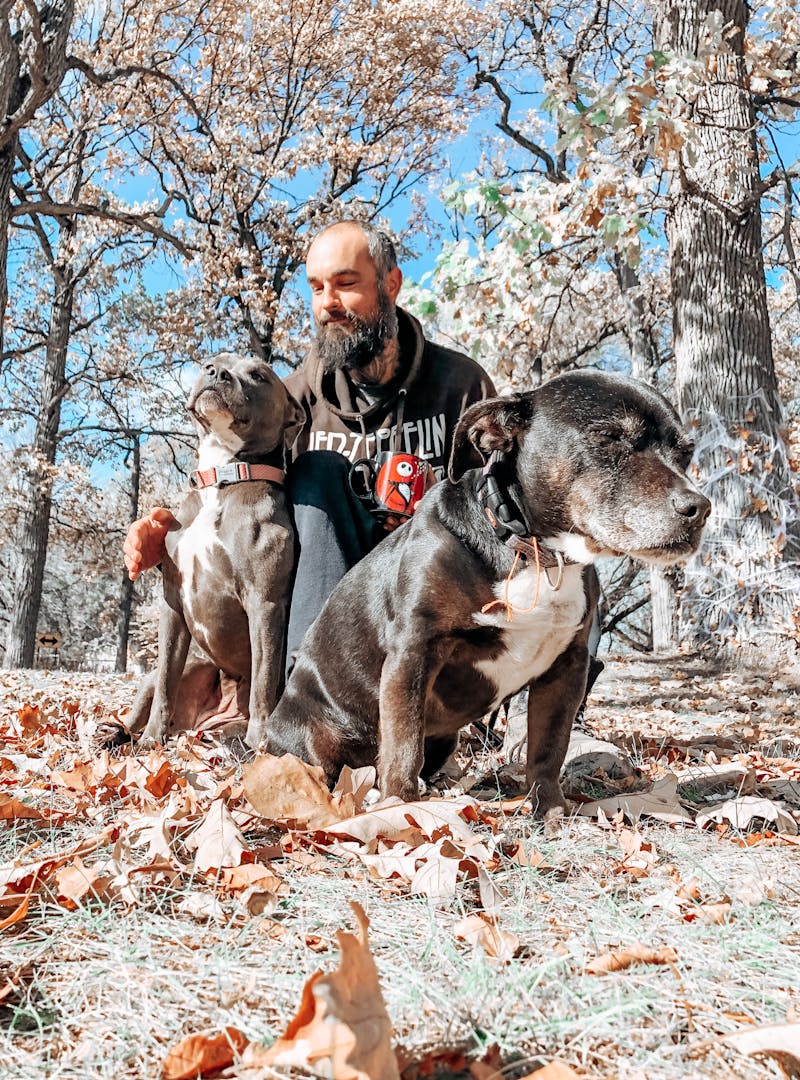 Justin Russell and his two dogs enjoy some sun on a fall day.