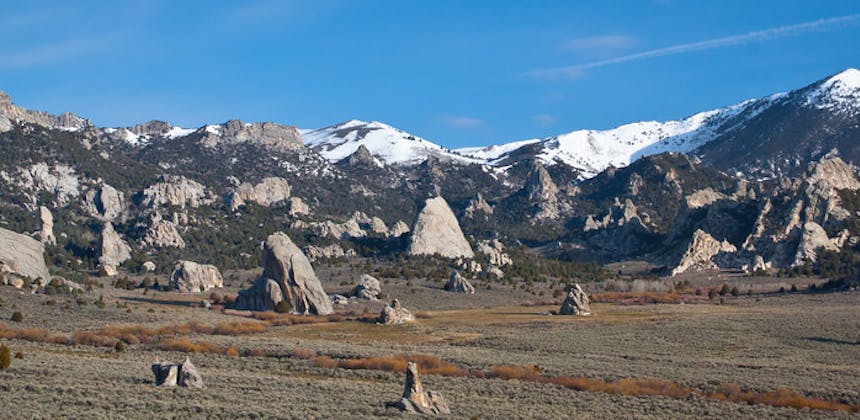 The rocky base of snowcapped mountains.