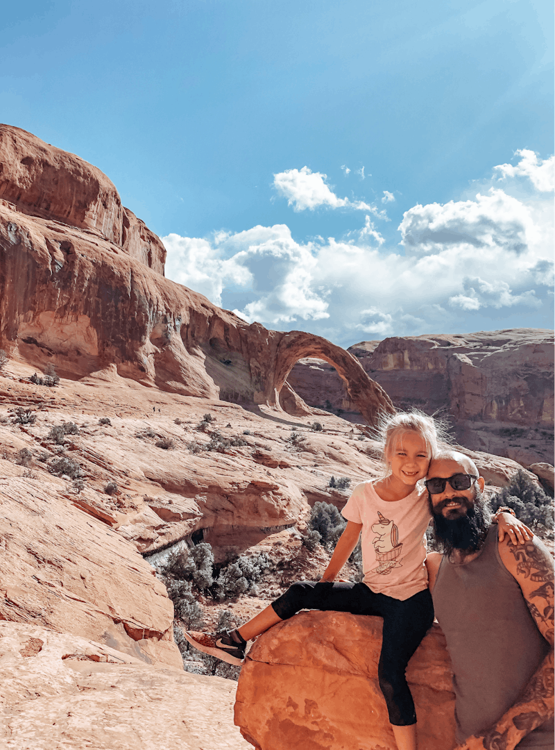 Justin Russell and his daughter pose for a picture on a hike.