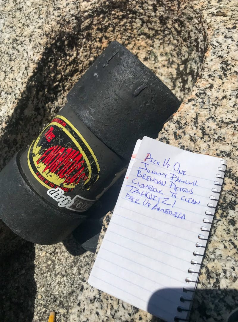 Black container to collect trash and notepad with blue ink notes
