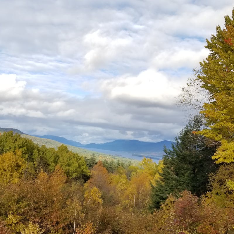 View of orange trees and clouds from the top of Prospect Mountain, New York