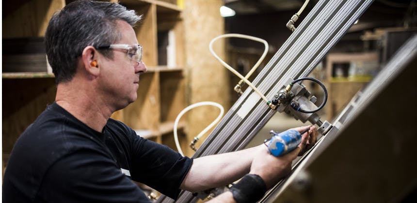 Factory worker using high tech equipment