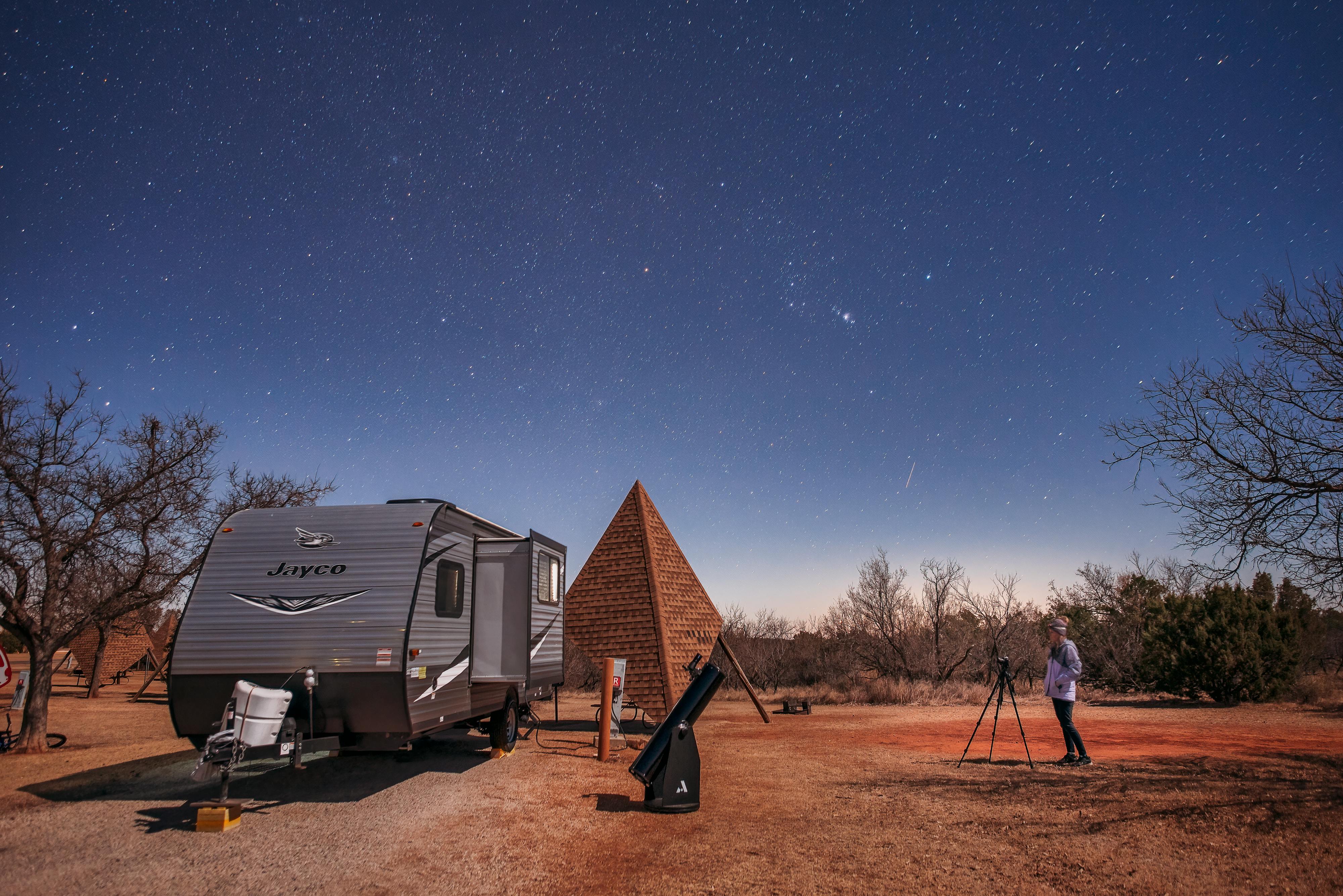 Alison Takacs sets up a shot of her Jayco RV and the night sky