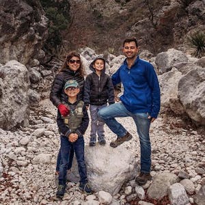 The Selm family posed for a portrait on a rocky hillside.