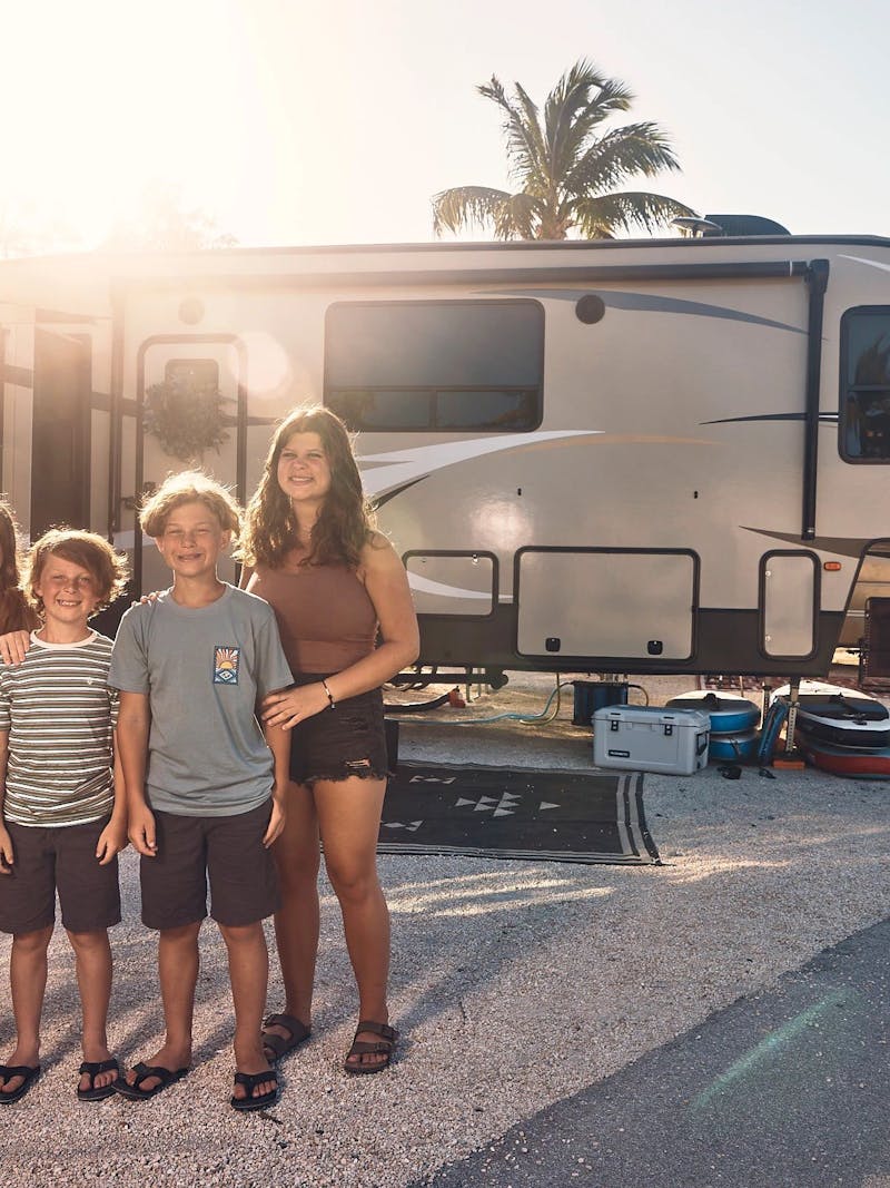 Lane Family kids pose for a picture in front of their RV