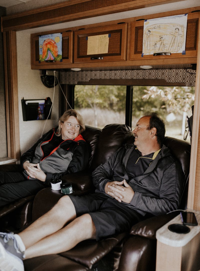 The Bolands putting their feet up in the recliner chairs inside their Thor Vegas RV.