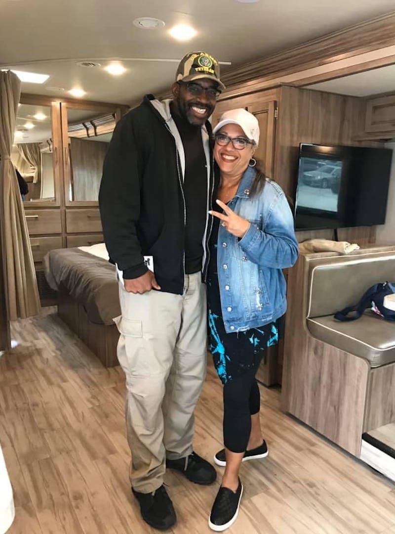 Kirsten and Mack Womack posing inside their Entegra Odyssey Class C RV on the day they purchased it.