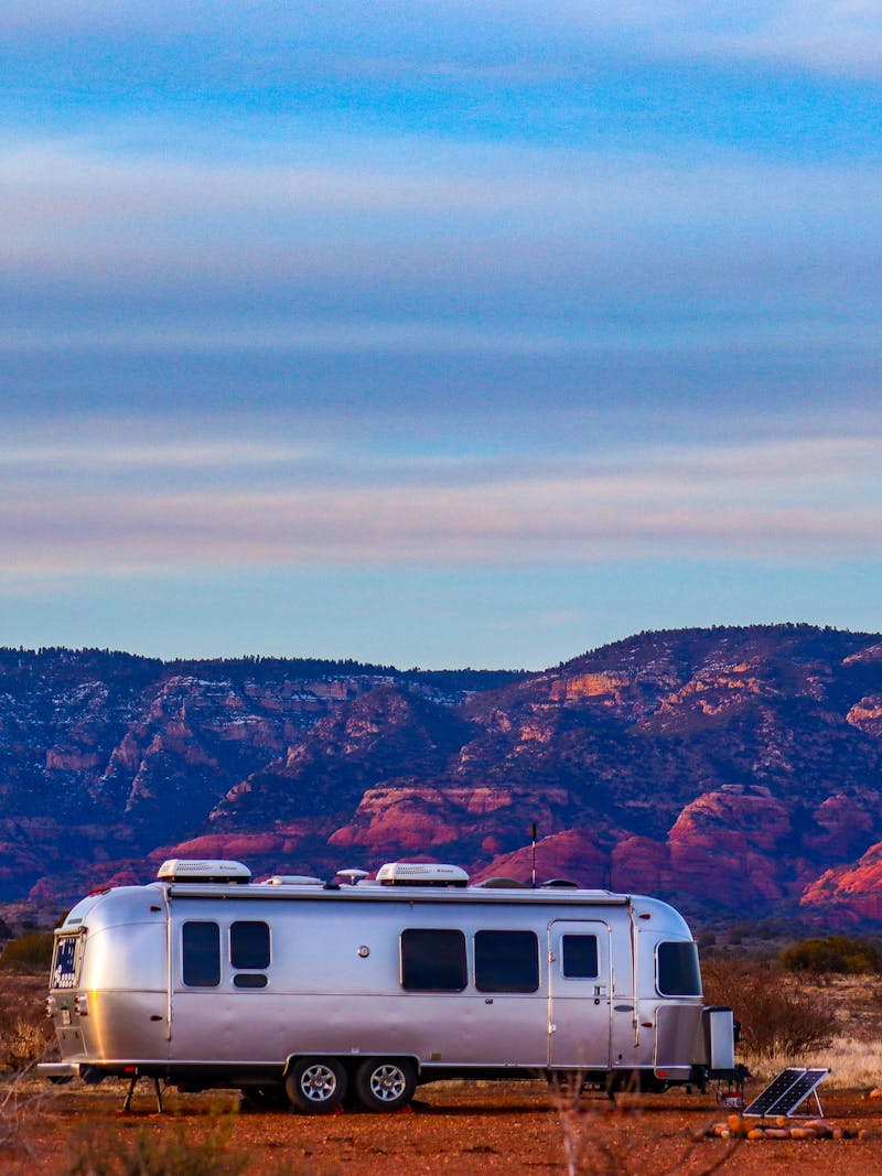 Greg Graham's Airstream parked by mountains at sunset. 