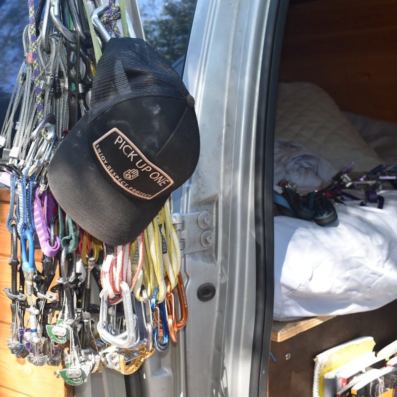 Hat and climbing gear and clips hanging on van